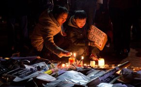 People in Place de Republique gather round tributes to those that were killed - Guardian news
